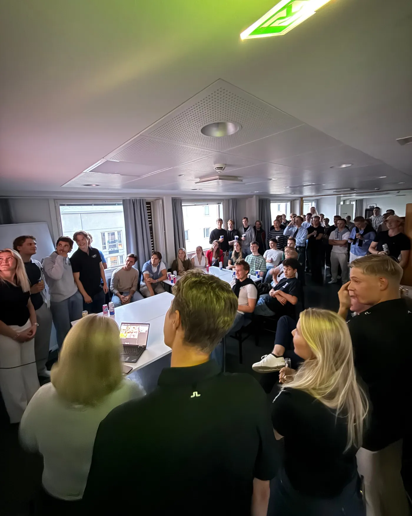 A full room of new students at an orientation week event